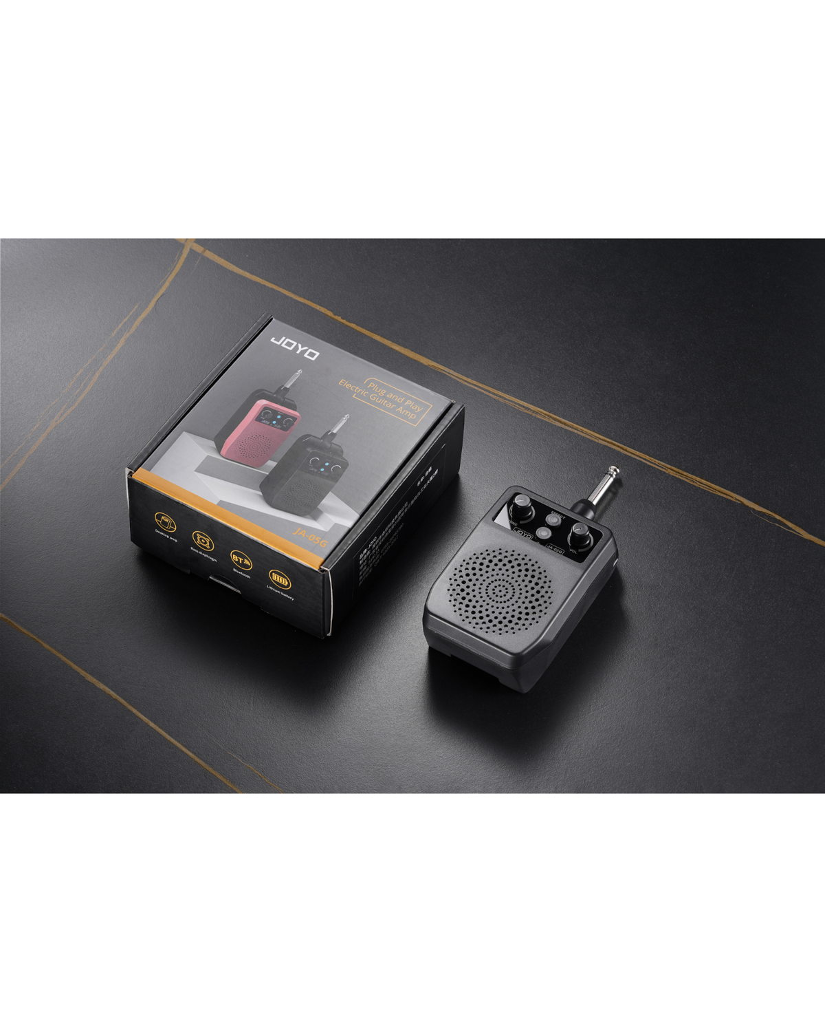 Haze Guitar Australia Joyo JA05G portable electric guitar mini amp with its black retail box on a dark surface